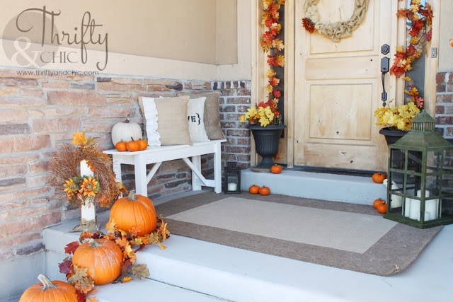 10 Fall Front Porch Ideas by A Blissful Nest - This front porch fall decor uses rich colors and cute little pumpkins to make a bold fall statement! The fresh flower arrangements complete the look. 