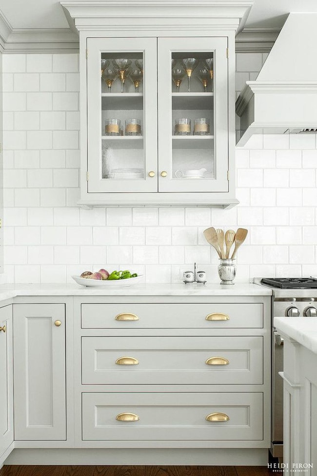 This all-white kitchen pops with gorgeous gold accents and a lovely subway tile backsplash. This is how you decorate with neutral colors!
