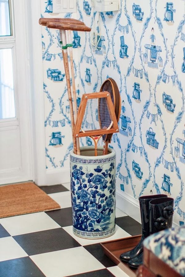 Adore the whimsical touch of this blue and white umbrella stand in a entry.