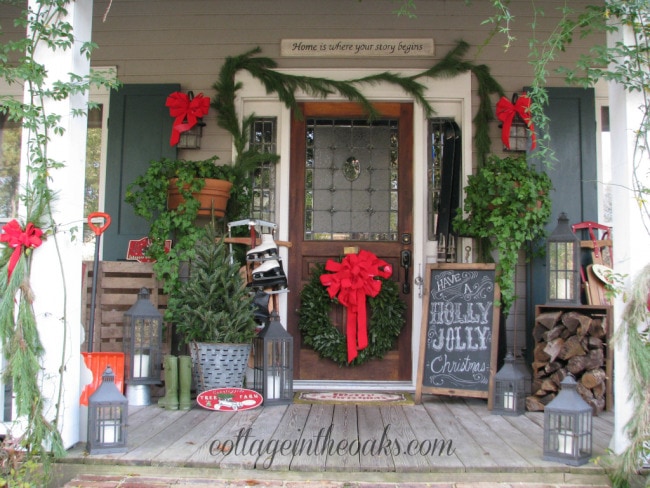 Cottage in the Oaks Christmas Porch, Chalkboard Art, Ice Skates, Sled, Fresh Garland - Christmas porch ideas from A Blissful Nest