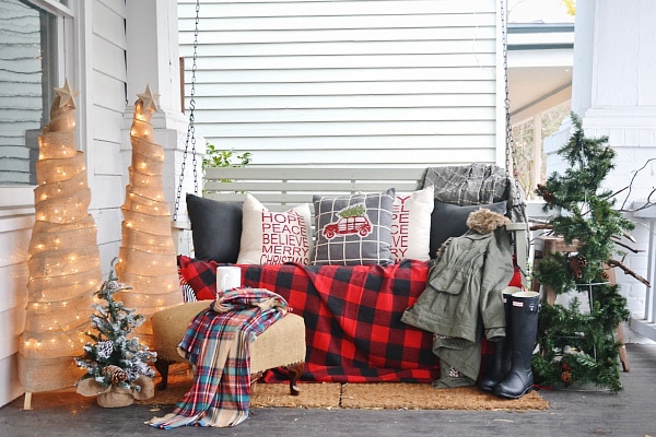 Liz Marie Blog Christmas Porch, Burlap trees, Charlie Brown Tree, Plaid blankets, Christmas Pillows - Christmas porch ideas from A Blissful Nest