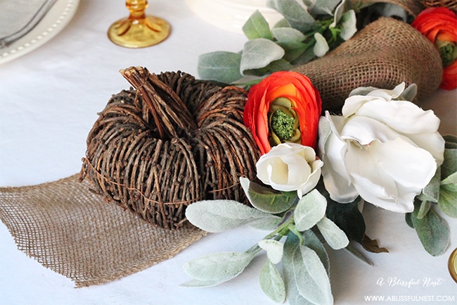 use beautiful faux flowers wrapped with burlap and grapevine pumpkins for the center of your table.