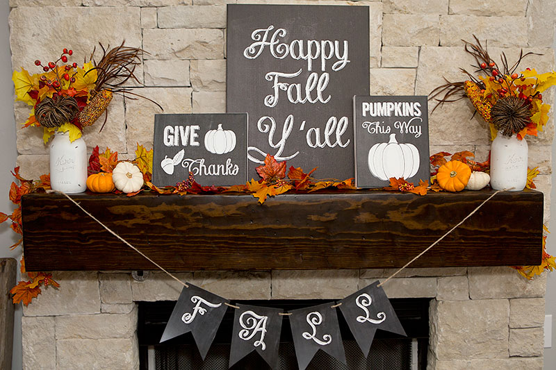 A beautiful and colorful fall mantel with chalkboard signs and fall foliage.
