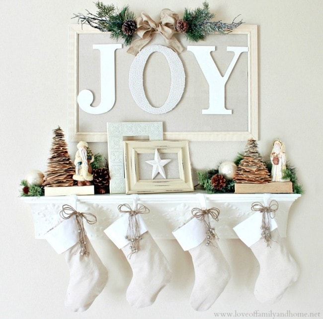 Christmas mantels - white stockings, pine cone trees, white and gold accents - Christmas Mantel Love of Family and Home