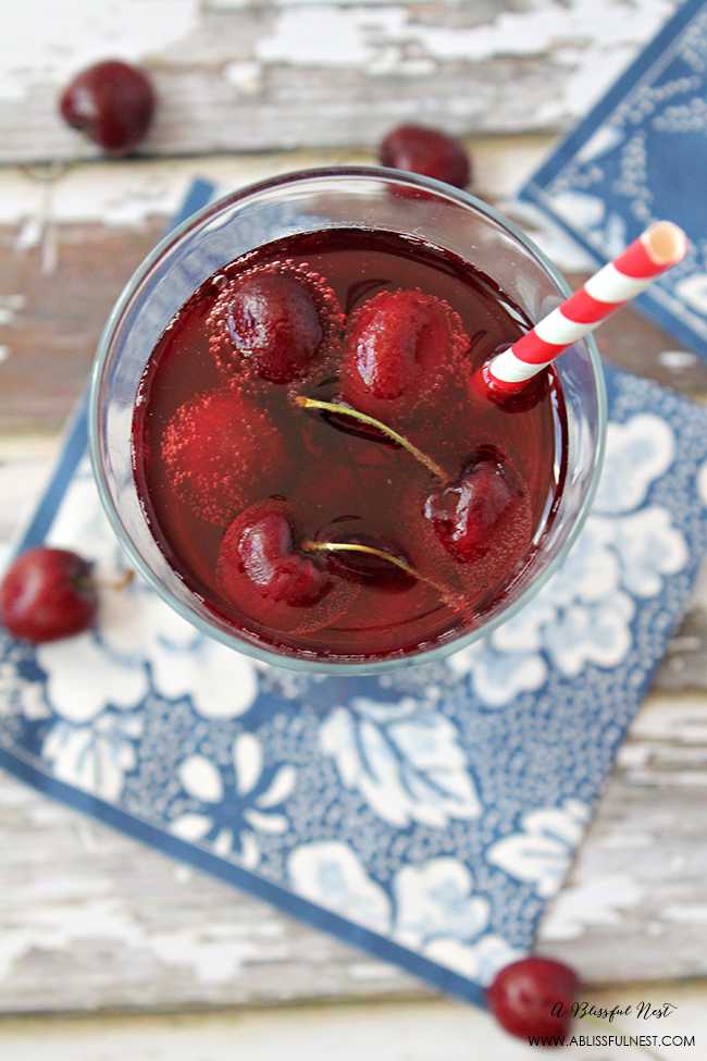 This delicious and refreshing cocktail recipe packs a punch! Full cherry sangria cocktail recipe details at ablissfulnest.com