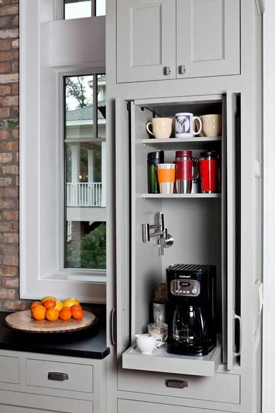 A pull out shelf to hold the coffee maker with a cabinet door to conceal it.