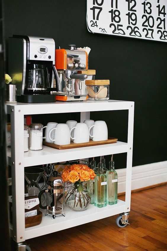 A white bar cart being used as a coffee station to save counter space.