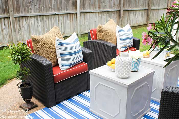 If you've got a small patio then you are not alone. BUT you do not have to sacrifice that designer look because of space issues. We are showing you simple tips to get that designer look with these small patio solutions. Via A Blissful Nest https://ablissfulnest.com #patiodecor #backyarddecor #homedecor #interiordesign #designtips