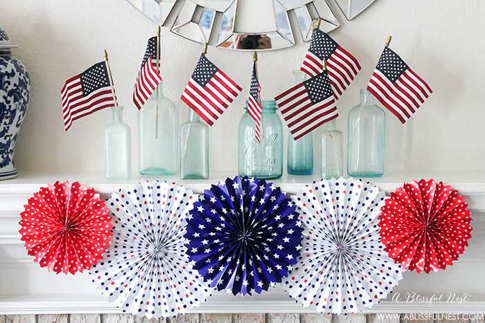 I adore the vintage Americana 4th of July mantle decor! With pops of aqua this is the perfect 4th of July decor by A Blissful Nest. https://ablissfulnest.com #4thofjuly #redwhiteandblue #4thofjulydecor