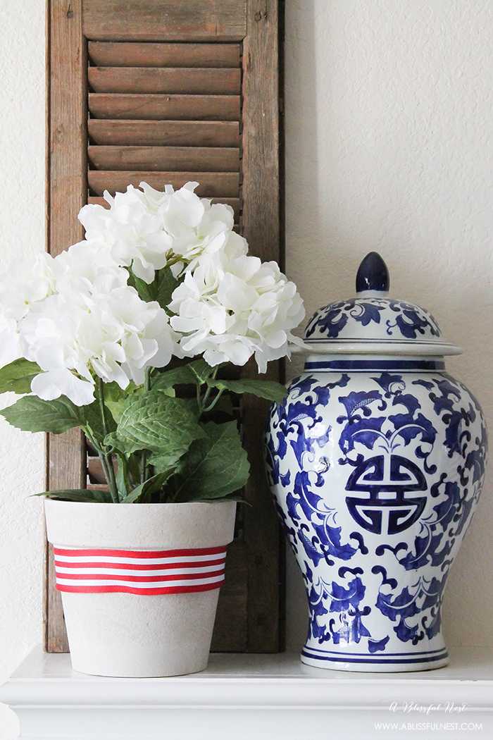 I adore the vintage Americana 4th of July mantle decor! With pops of aqua this is the perfect 4th of July decor by A Blissful Nest. https://ablissfulnest.com #4thofjuly #redwhiteandblue #4thofjulydecor