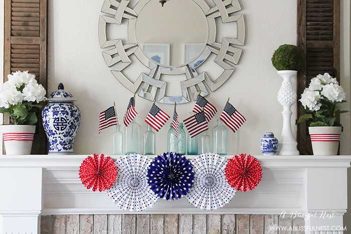 I adore the vintage Americana 4th of July mantle decor! With pops of aqua this is the perfect 4th of July decor by A Blissful Nest. https://ablissfulnest.com #4thofjuly #redwhiteandblue #4thofjulydecor