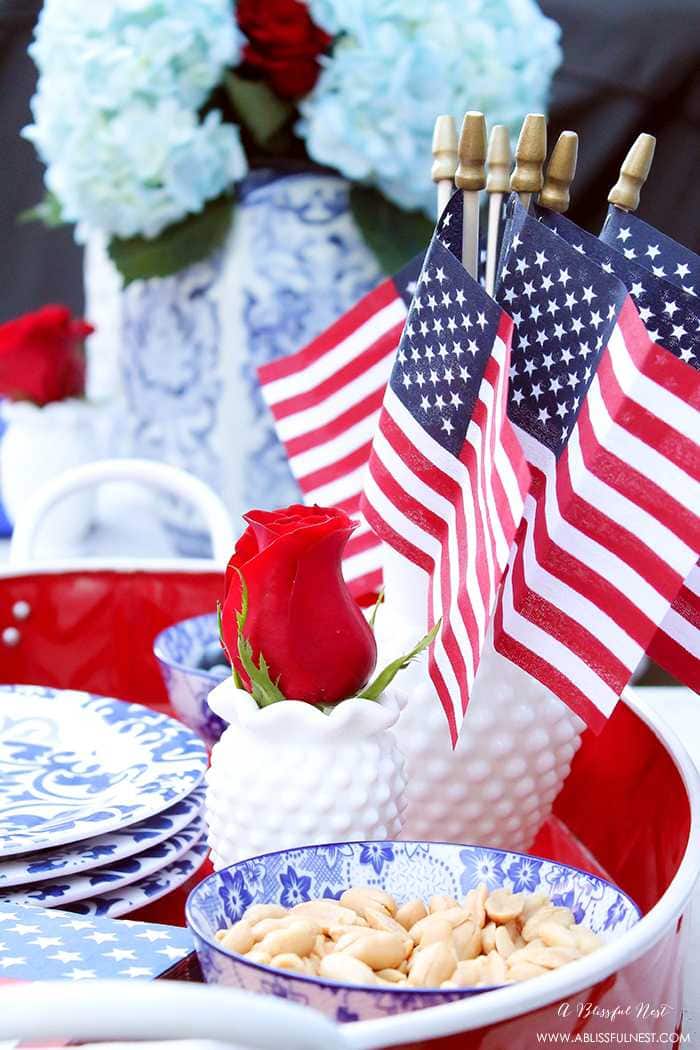 These are such great ideas to celebrate 4th of July with! I love all the Americana red, white and blue pops of color on this patio. Check out more on A Blissful Nest. https://ablissfulnest.com #4thofjuly #4thofjulydecor #redwhiteandblue