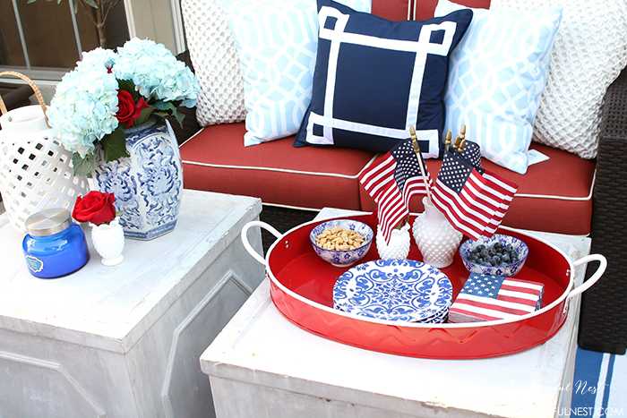 These are such great ideas to celebrate 4th of July with! I love all the Americana red, white and blue pops of color on this patio. Check out more on A Blissful Nest. https://ablissfulnest.com #4thofjuly #4thofjulydecor #redwhiteandblue