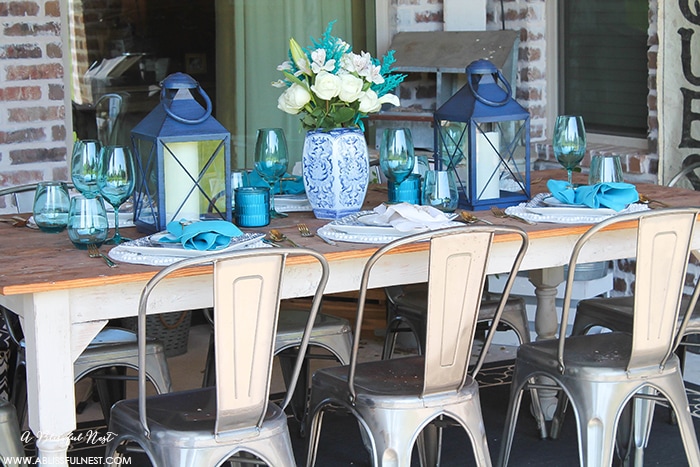 Fresh coastal table décor ideas for the perfect summer night. Grab these tips on setting the perfect coastal tablescape by A Blissful Nest. https://ablissfulnest.com/ #coastal #tabledecor #tabledecorideas #coastalinteriors #coastalroom #ocean #blueandwhite