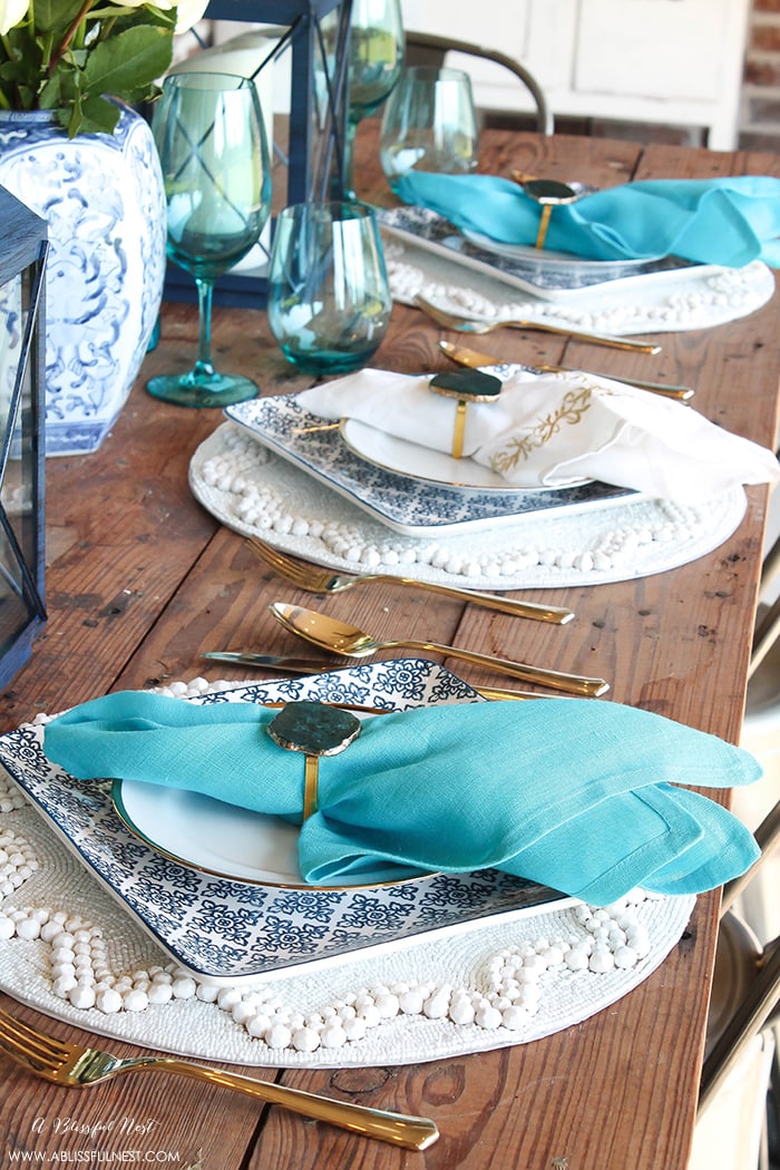 Fresh coastal table décor ideas for the perfect summer night. Grab these tips on setting the perfect coastal tablescape by A Blissful Nest. https://ablissfulnest.com/ #coastal #tabledecor #tabledecorideas #coastalinteriors #coastalroom #ocean #blueandwhite