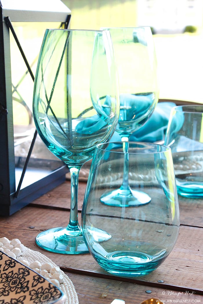 Fresh coastal table décor ideas for the perfect summer night. Grab these tips on setting the perfect coastal tablescape by A Blissful Nest. https://ablissfulnest.com/ #coastal #tabledecor #tabledecorideas #coastalinteriors #coastalroom #ocean #blueandwhite