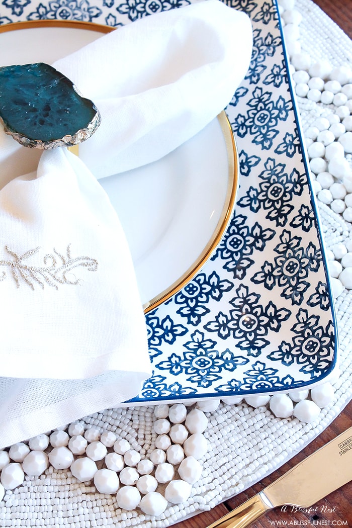 Fresh coastal table décor ideas for the perfect summer night. Grab these tips on setting the perfect coastal tablescape by A Blissful Nest. https://ablissfulnest.com/ #coastal #tabledecor #tabledecorideas #coastalinteriors #coastalroom #ocean #blueandwhite