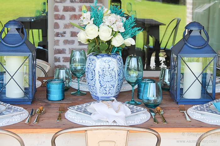 Fresh coastal table décor ideas for the perfect summer night. Grab these tips on setting the perfect coastal tablescape by A Blissful Nest. https://ablissfulnest.com/ #coastal #tabledecor #tabledecorideas #coastalinteriors #coastalroom #ocean #blueandwhite