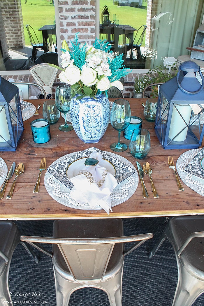 Fresh coastal table décor ideas for the perfect summer night. Grab these tips on setting the perfect coastal tablescape by A Blissful Nest. https://ablissfulnest.com/ #coastal #tabledecor #tabledecorideas #coastalinteriors #coastalroom #ocean #blueandwhite