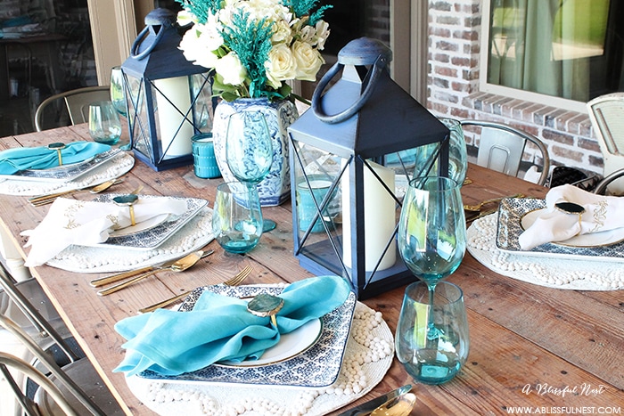 Fresh coastal table décor ideas for the perfect summer night. Grab these tips on setting the perfect coastal tablescape by A Blissful Nest. https://ablissfulnest.com/ #coastal #tabledecor #tabledecorideas #coastalinteriors #coastalroom #ocean #blueandwhite