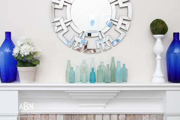 Such an easy tutorial on how to create DIY sea glass bottles using spray paint. Literally 2 steps to get this coastal décor look! See how on https://ablissfulnest.com/ #coastaldecorating #seaglassbottle #designtips #howtomake #diyseaglassbottles