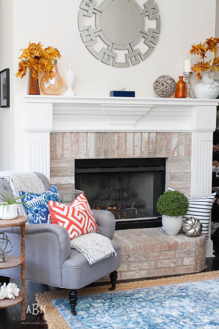 Check out these gorgeous coastal accents in this fall home tour with A Blissful Nest! Love the pops of orange in this home with its neutral pallet. See more at https://ablissfulnest.com/ #fallfrontporch #falldecorating #falldecor #fallhometour