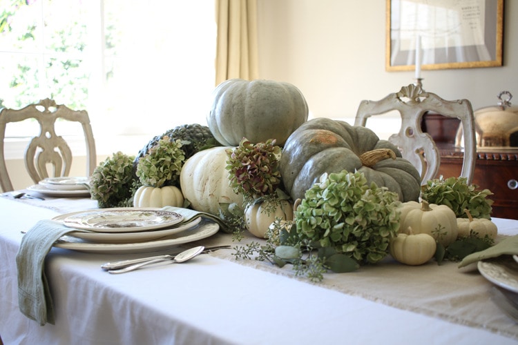 This neutral Fall tablescape is full of natural elements, brown toile dishes and loads of pumpkins and dried florals. Visit https://ablissfulnest.com/ for all of the details! #NeutralDecor #Fall #FallTablescape