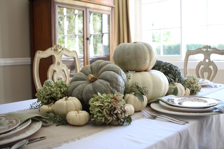 This neutral Fall tablescape is full of natural elements, brown toile dishes and loads of pumpkins and dried florals. Visit https://ablissfulnest.com/ for all of the details! #NeutralDecor #Fall #FallTablescape