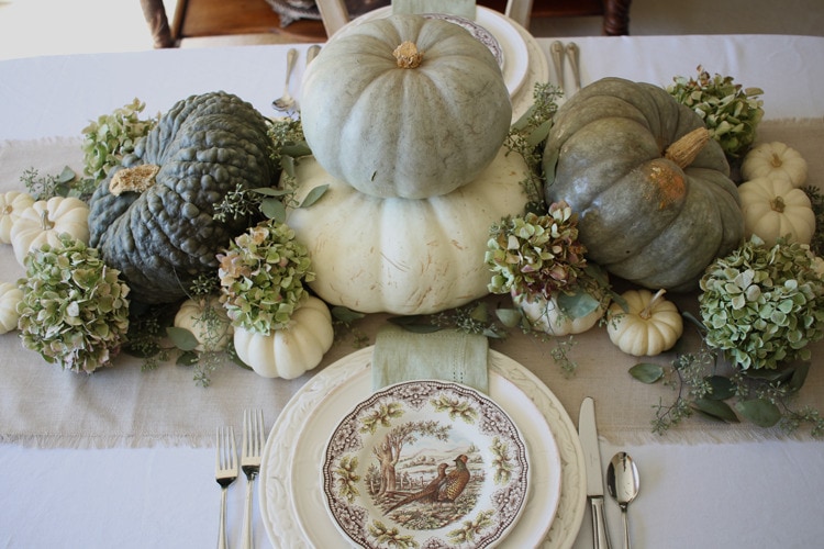 This neutral Fall tablescape is full of natural elements, brown toile dishes and loads of pumpkins and dried florals. Visit https://ablissfulnest.com/ for all of the details! #NeutralDecor #Fall #FallTablescape