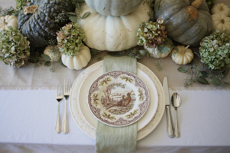 This neutral Fall tablescape is full of natural elements, brown toile dishes and loads of pumpkins and dried florals. Visit https://ablissfulnest.com/ for all of the details! #NeutralDecor #Fall #FallTablescape