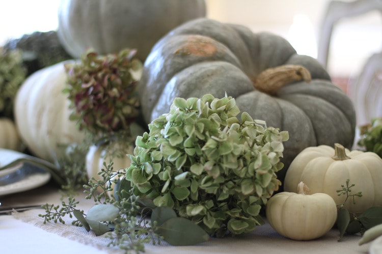 This neutral Fall tablescape is full of natural elements, brown toile dishes and loads of pumpkins and dried florals. Visit https://ablissfulnest.com/ for all of the details! #NeutralDecor #Fall #FallTablescape