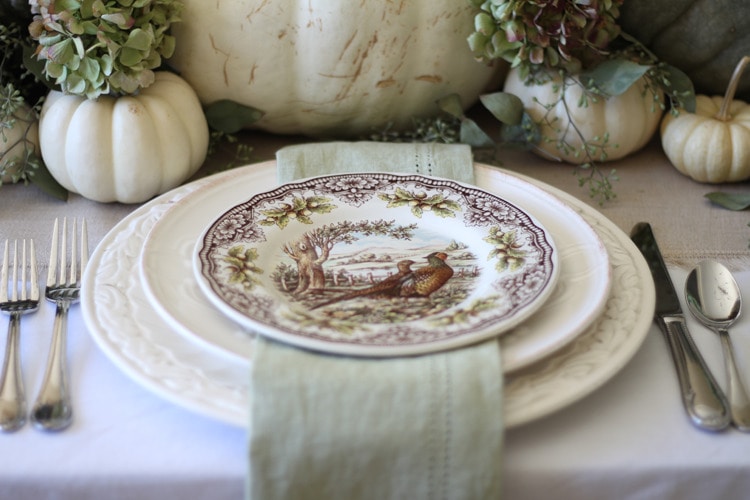 This neutral Fall tablescape is full of natural elements, brown toile dishes and loads of pumpkins and dried florals. Visit https://ablissfulnest.com/ for all of the details! #NeutralDecor #Fall #FallTablescape