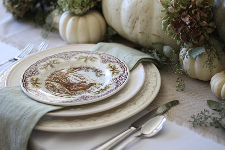 This neutral Fall tablescape is full of natural elements, brown toile dishes and loads of pumpkins and dried florals. Visit https://ablissfulnest.com/ for all of the details! #NeutralDecor #Fall #FallTablescape