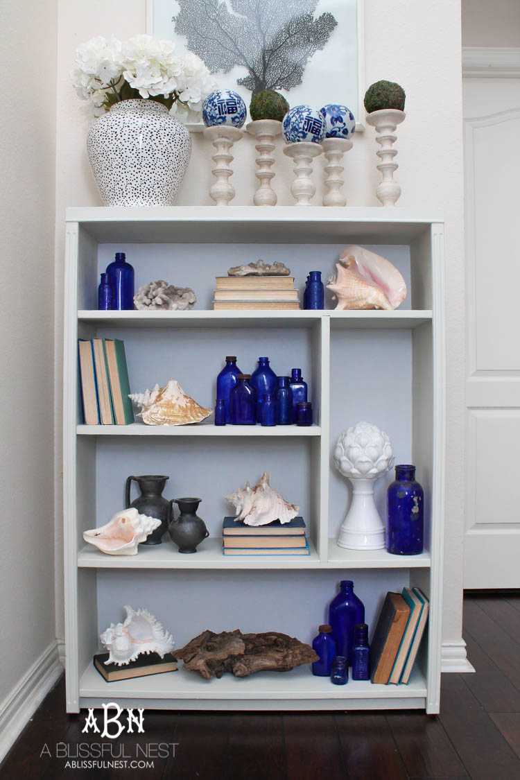 Got an old bookcase that needs to be updated? Checkout how this bookcase went from boring to fabulous with just a few easy steps! See more on https://ablissfulnest.com/ #bookcasemakeover #diybookcase #chalkfurniturepaint