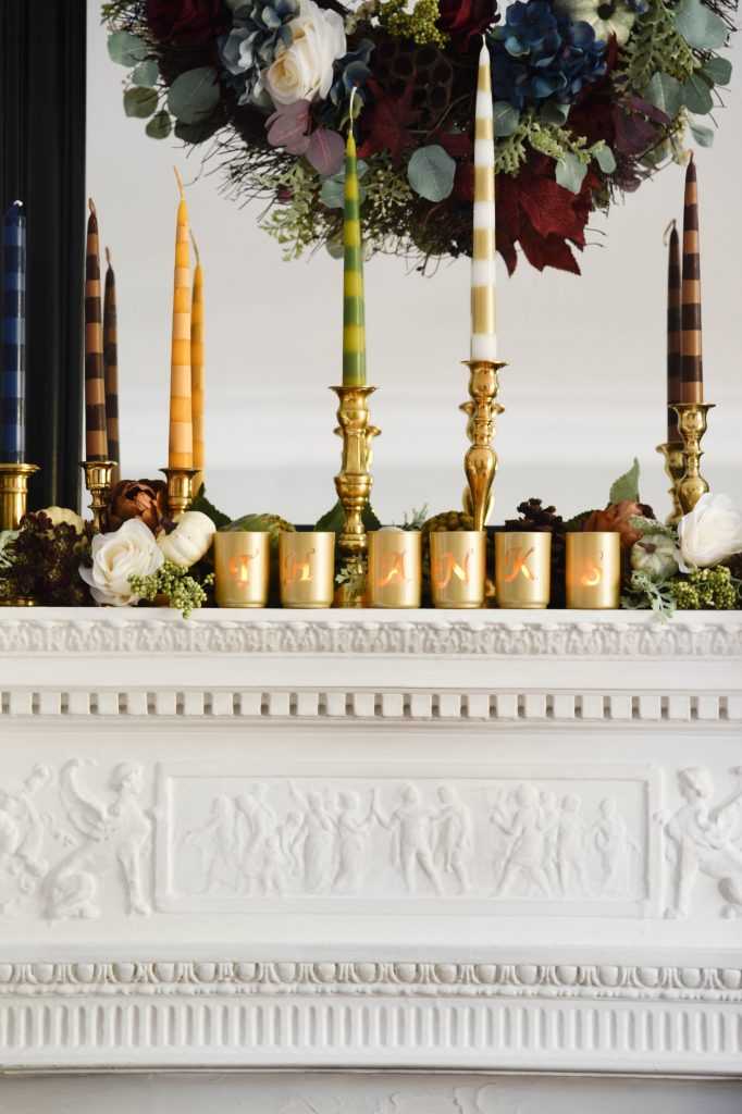 Learn how to make your own striped taper candles and painted votive candle holders for any occasion. A gorgeous Thanksgiving mantel brimming with color. See it all at https://ablissfulnest.com/ #Thanksgiving #DIY #HolidayDIY