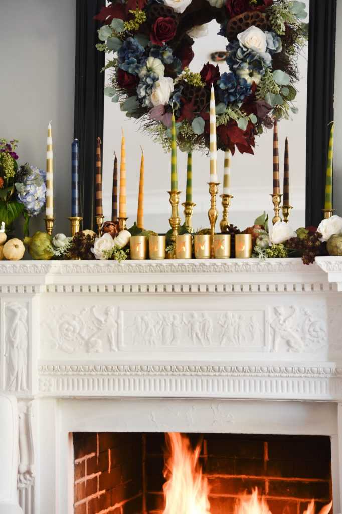 Learn how to make your own striped taper candles and painted votive candle holders for any occasion. A gorgeous Thanksgiving mantel brimming with color. See it all at https://ablissfulnest.com/ #Thanksgiving #DIY #HolidayDIY