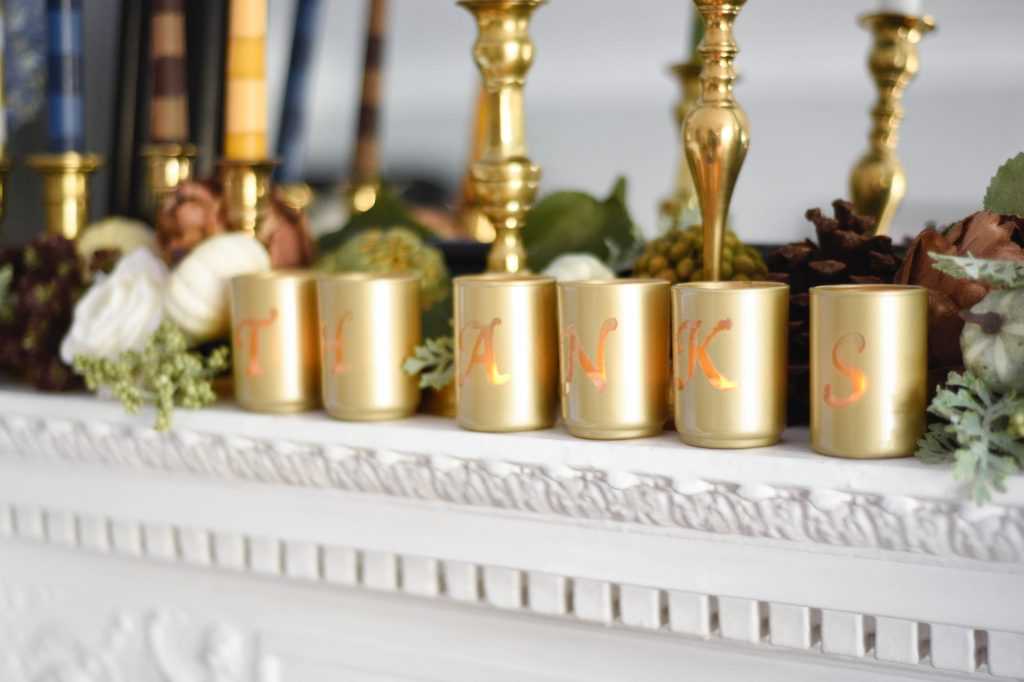 Learn how to make your own striped taper candles and painted votive candle holders for any occasion. A gorgeous Thanksgiving mantel brimming with color. See it all at https://ablissfulnest.com/ #Thanksgiving #DIY #HolidayDIY
