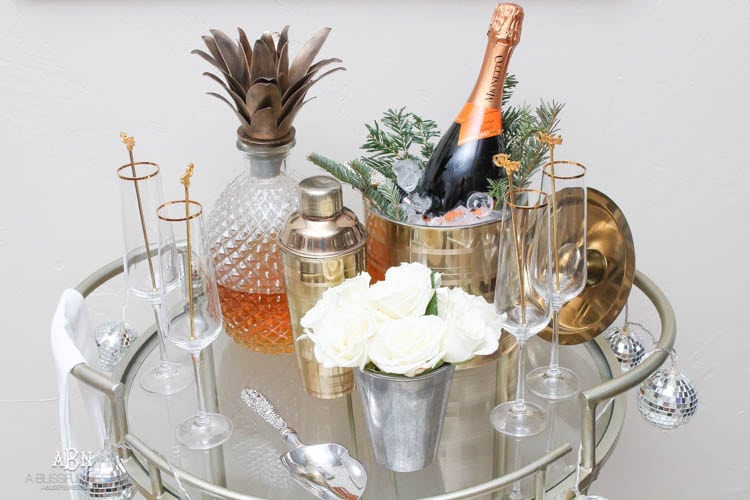 These are such great ideas to transition your Christmas décor into celebrating New Years Eve! Love all the gold and sparkly accents! See more on https://ablissfulnest.com/ #newyearseve #newyearsbarcart #ad #Pier1Love