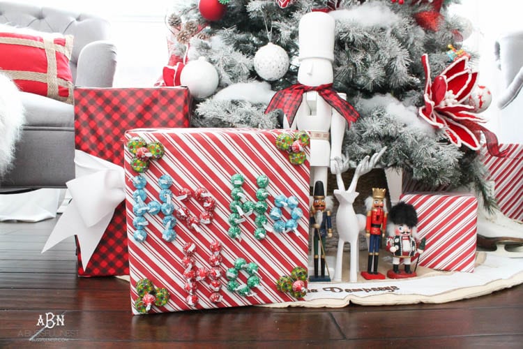 Wrap your presents in chocolaty goodness with Hershey’s Kisses! This is such a fun and unique idea to decorate a gift. Then they can eat the candy later after the present has been opened! So fun! See more on https://ablissfulnest.com/ #hersheyskiss #christmascraft #christmasdiyidea