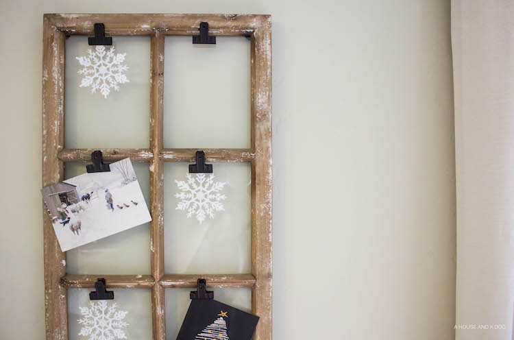 Use an old window and some clips to create a one-of-a-king Christmas card display. It makes for a beautiful decor piece in your home! See it all on https://ablissfulnest.com/ #Christmas #CHristmasCards #VintageDecor