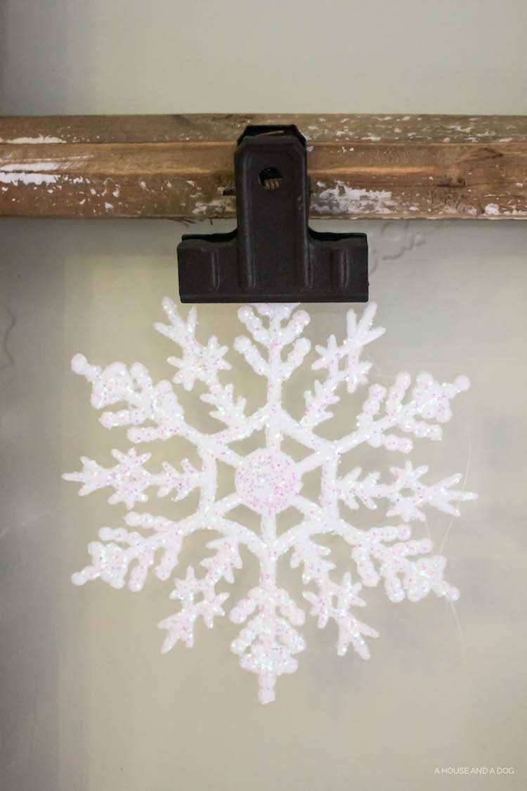 Use an old window and some clips to create a one-of-a-king Christmas card display. It makes for a beautiful decor piece in your home! See it all on https://ablissfulnest.com/ #Christmas #CHristmasCards #VintageDecor