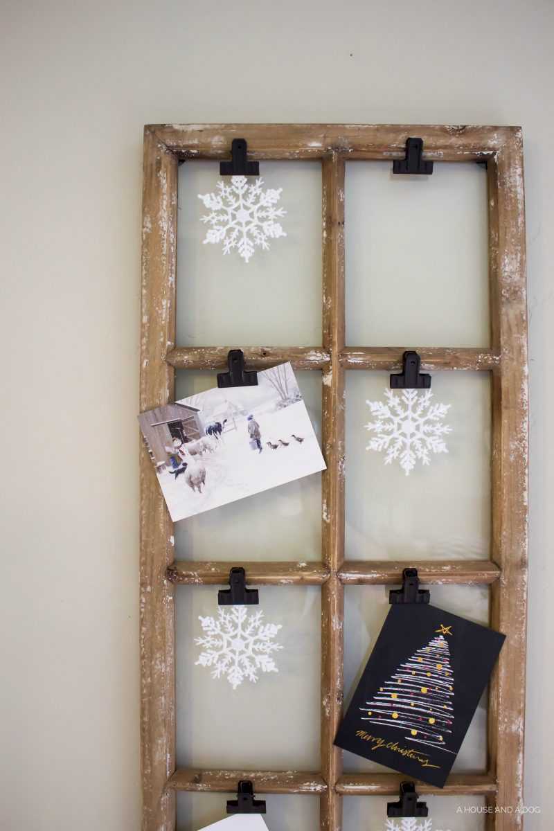 Use an old window and some clips to create a one-of-a-king Christmas card display. It makes for a beautiful decor piece in your home! See it all on https://ablissfulnest.com/ #Christmas #CHristmasCards #VintageDecor