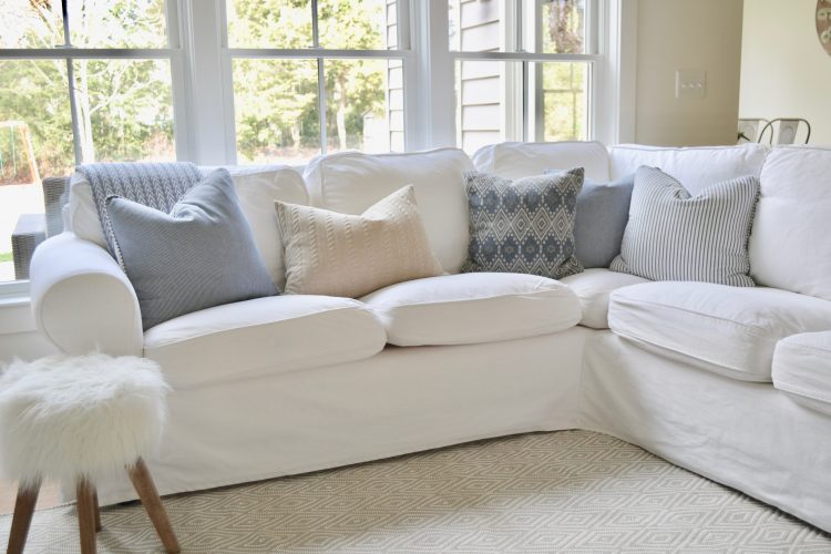 This bright, crisp couch with cool grey pillows and simple pattern fabrics go a long way in helping you refresh your home in the new year!