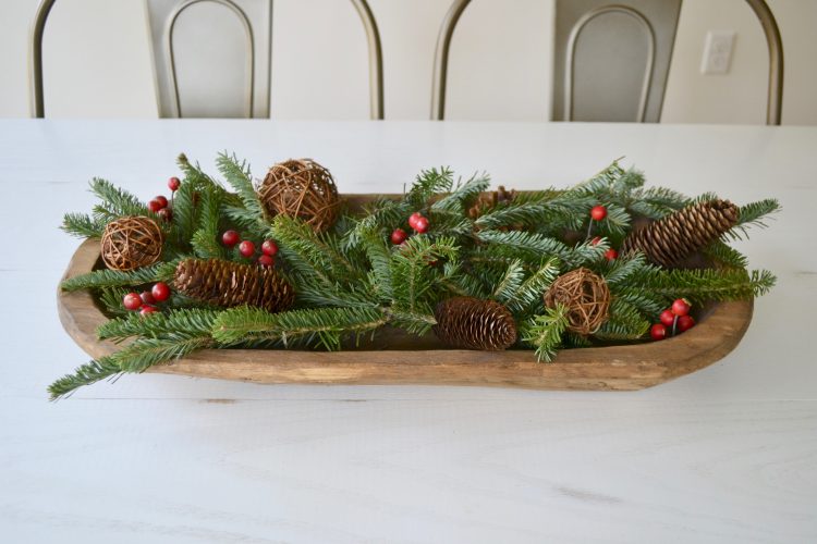 It's easy to refresh your home with some simple greenery. This beautiful and colorful balsam, pinecone and holly table centerpiece keeps the winter vibe in your refreshed home. 