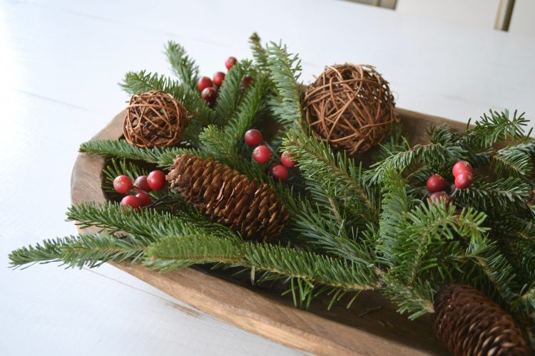 A pop of red and green color will refresh your home with this simple and wintery dining room table centerpiece. 