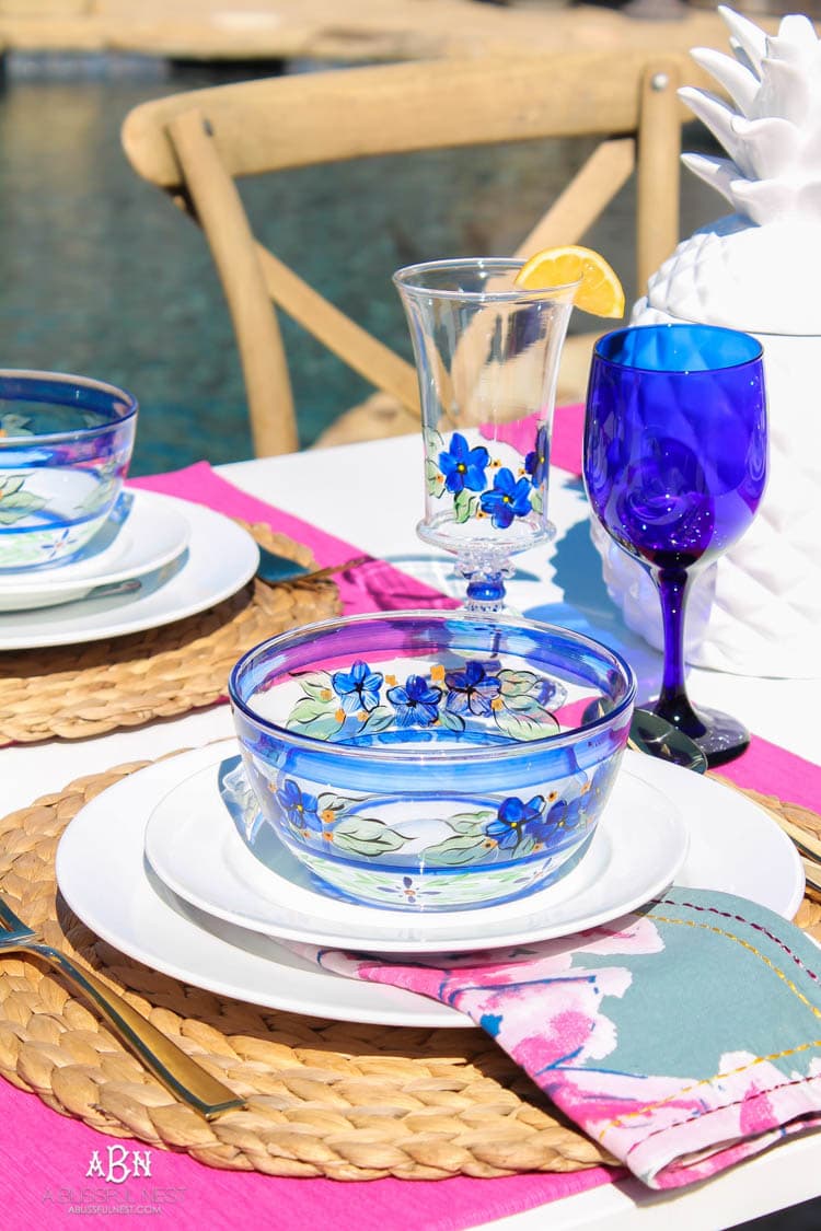 A bright and fresh spring table setting idea perfect for Easter, Mother's Day or a pool party! See more on https://ablissfulnest.com/ #tablesetting #tablescape #springtabledecor 