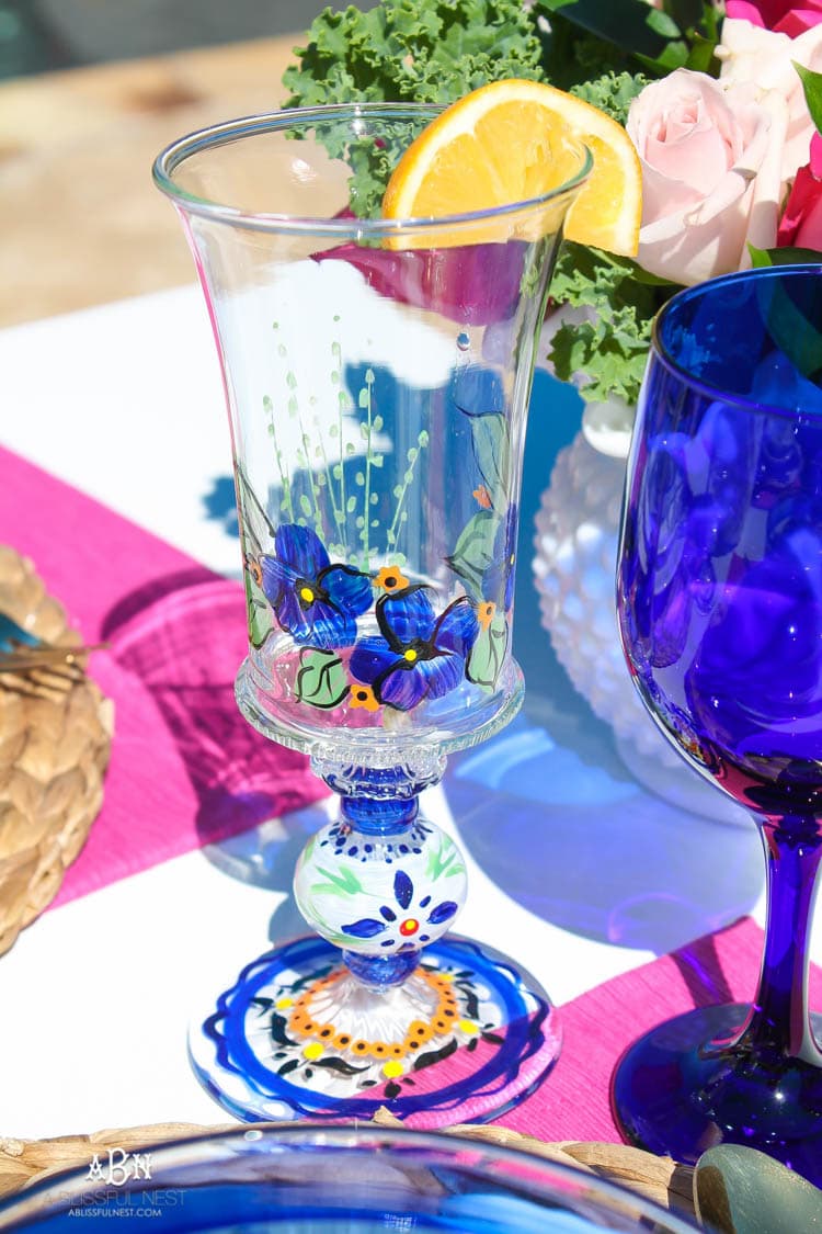 A bright and fresh spring table setting idea perfect for Easter, Mother's Day or a pool party! See more on https://ablissfulnest.com/ #tablesetting #tablescape #springtabledecor