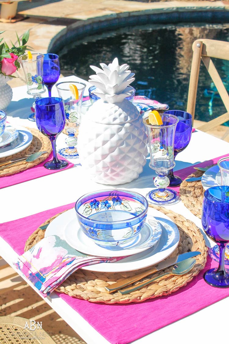 A bright and fresh spring table setting idea perfect for Easter, Mother's Day or a pool party! See more on https://ablissfulnest.com/ #tablesetting #tablescape #springtabledecor