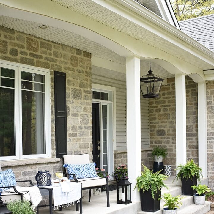 Just adore this extended porch with it's blue and white details from Citrine Living! #spring #springporch #springdecorating #springfrontporch