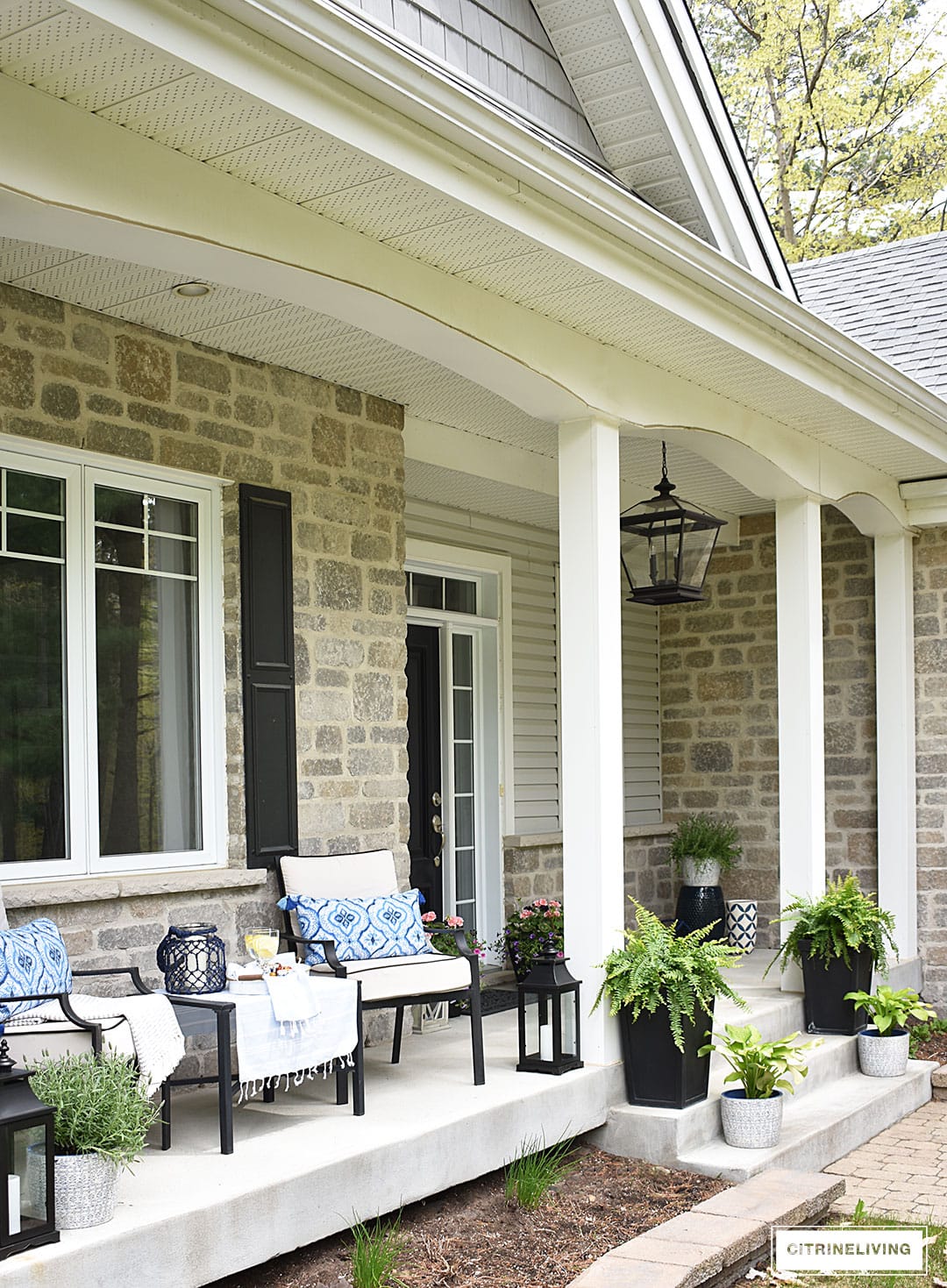 Just adore this extended porch with it's blue and white details from Citrine Living! #spring #springporch #springdecorating #springfrontporch